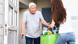 Ein Senior lässt sich Lebensmittel nach Hauser bringen
