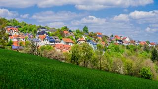 Wohngebiet mit Solardächern vor grüner Wiese